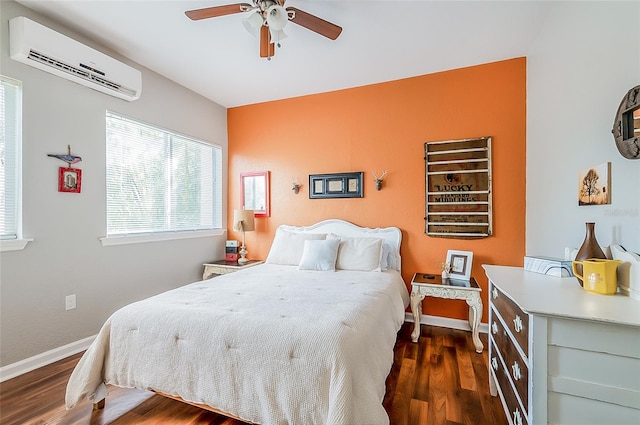 bedroom with ceiling fan, dark hardwood / wood-style flooring, and a wall unit AC