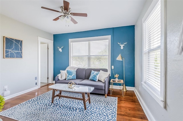 living room featuring ceiling fan, a healthy amount of sunlight, and dark hardwood / wood-style flooring