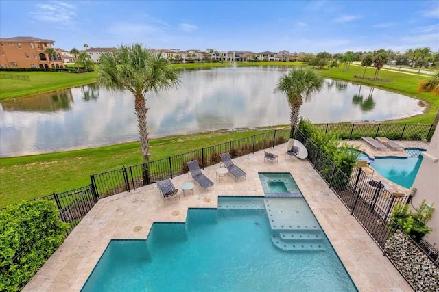 view of swimming pool featuring a patio, a water view, an in ground hot tub, and a yard