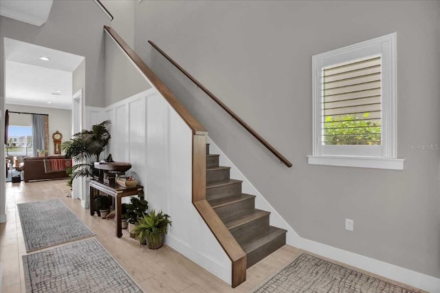 staircase featuring ornamental molding