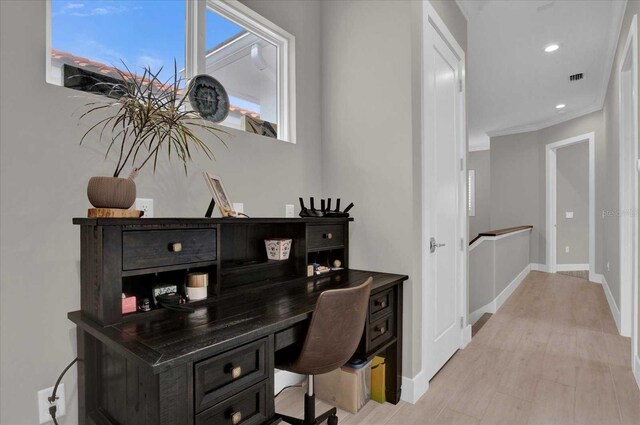 office space featuring ornamental molding and light hardwood / wood-style flooring