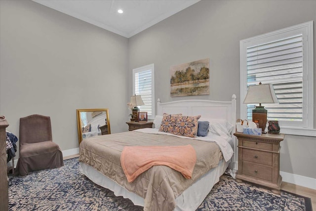 bedroom featuring wood-type flooring and ornamental molding