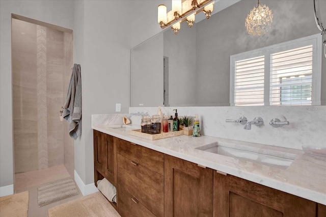 bathroom featuring vanity, a shower, and a notable chandelier