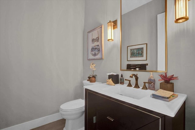 bathroom featuring hardwood / wood-style flooring, vanity, and toilet