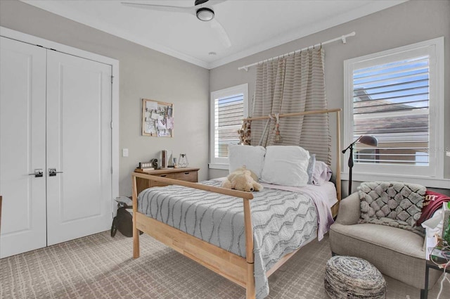 bedroom featuring a closet, ceiling fan, and crown molding