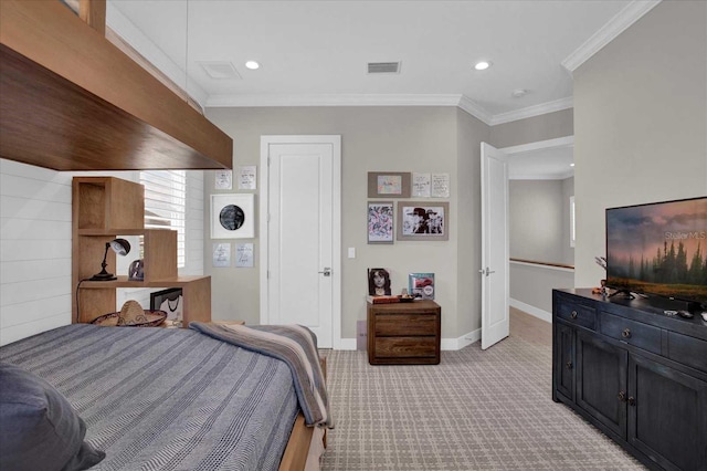 bedroom with ornamental molding and light colored carpet