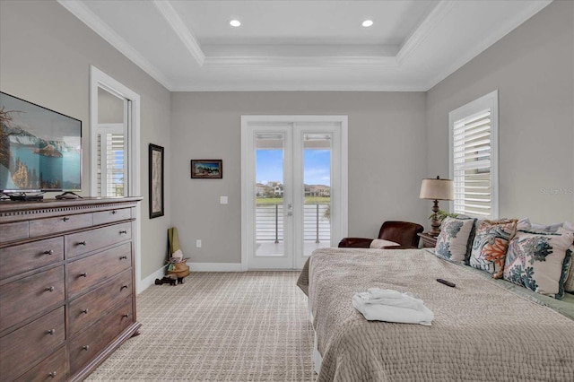 carpeted bedroom featuring ornamental molding, a tray ceiling, access to exterior, and french doors