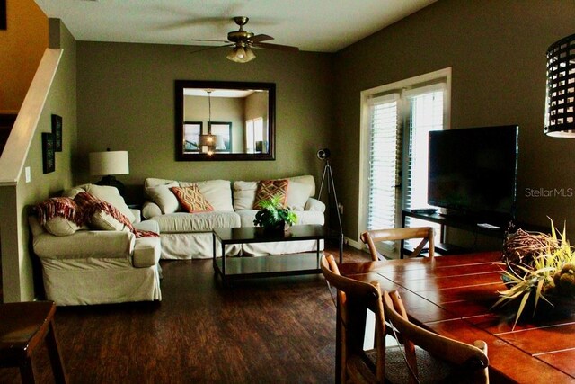 living room featuring ceiling fan and hardwood / wood-style flooring