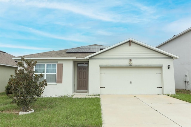 ranch-style home with a front yard, a garage, and solar panels