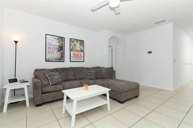 tiled living room with ceiling fan