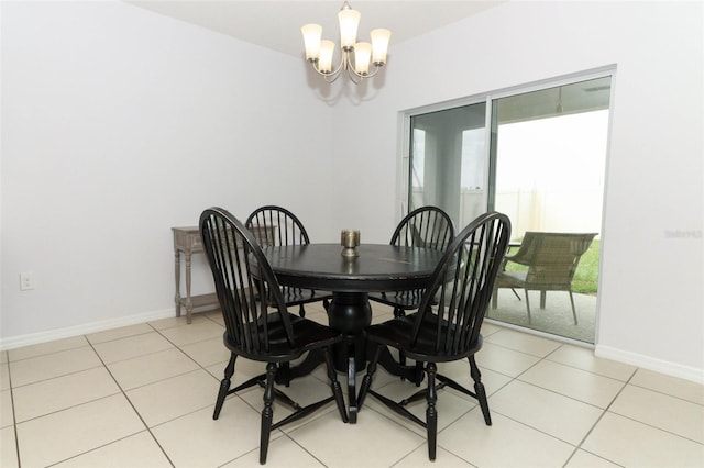 dining area featuring baseboards, a notable chandelier, and light tile patterned floors