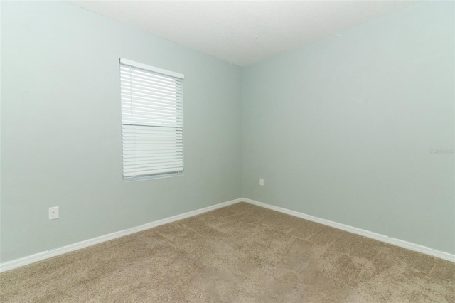 unfurnished room featuring light colored carpet