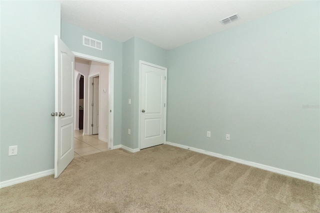 unfurnished bedroom with light colored carpet