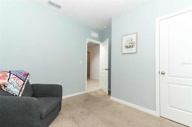 sitting room featuring light carpet