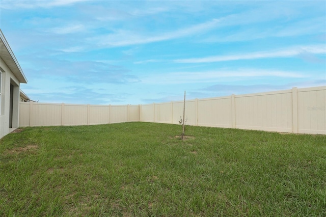 view of yard with a fenced backyard