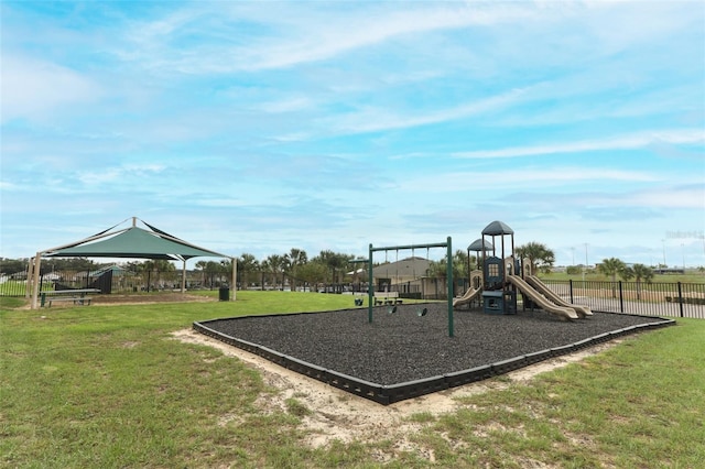 community jungle gym featuring a gazebo, a lawn, and fence