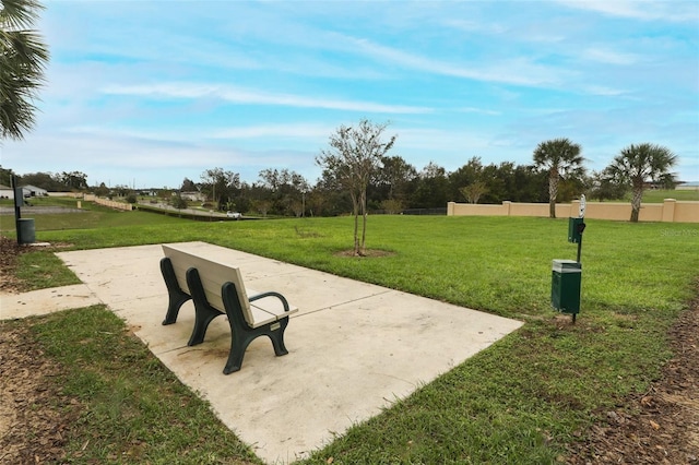 view of home's community featuring fence and a yard