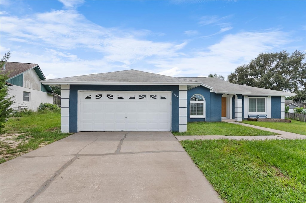 ranch-style home featuring a front lawn and a garage