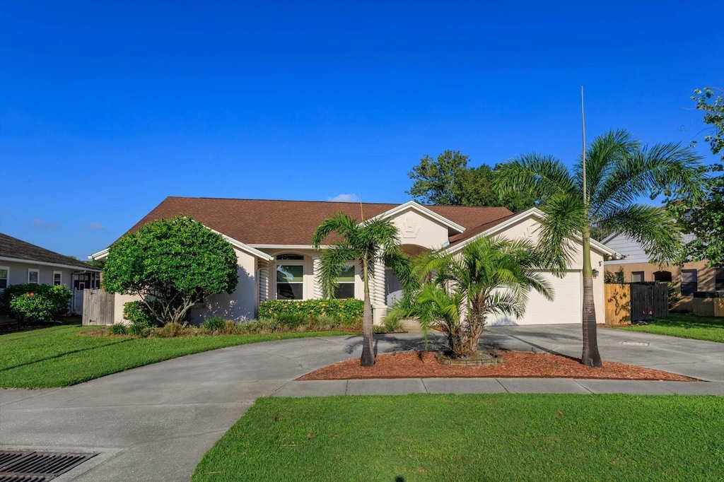 ranch-style house with a garage and a front yard