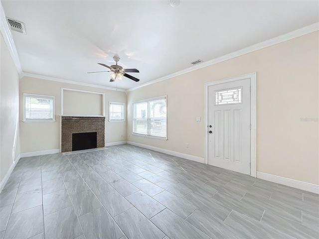 unfurnished living room with ornamental molding, ceiling fan, and a brick fireplace