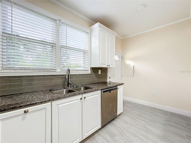 kitchen with dark stone counters, sink, white cabinets, backsplash, and stainless steel dishwasher