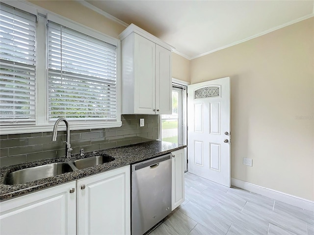 kitchen featuring decorative backsplash, dishwasher, dark stone counters, white cabinetry, and a sink