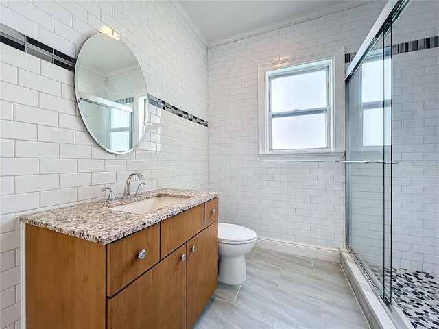 bathroom featuring tile walls, vanity, toilet, and an enclosed shower