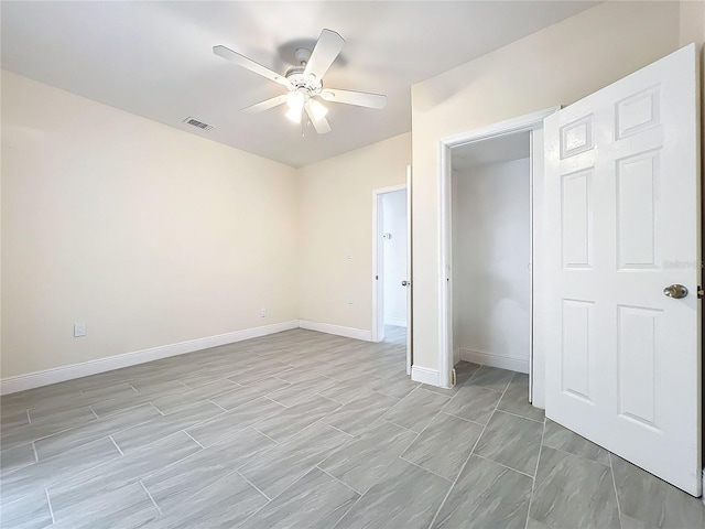 unfurnished bedroom featuring baseboards, ceiling fan, and visible vents