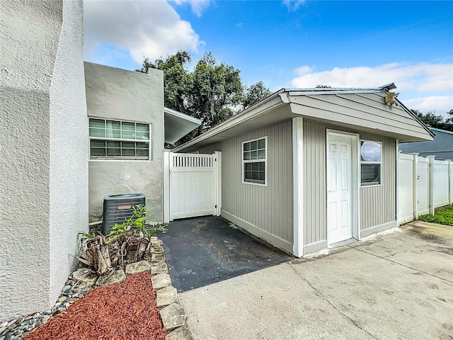 view of property exterior with central AC and a patio area