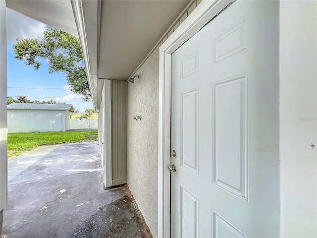 property entrance with stucco siding and a patio area