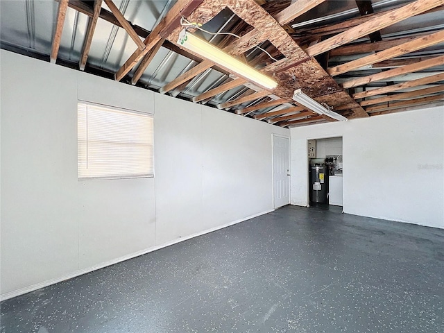 below grade area featuring water heater and separate washer and dryer