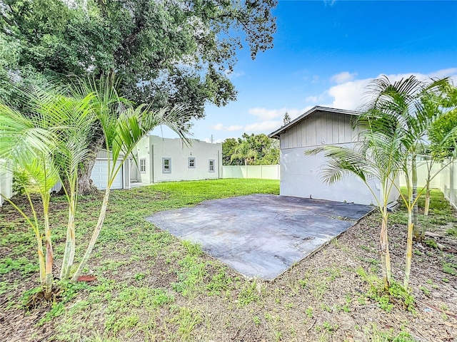 view of yard featuring a patio area and a garage