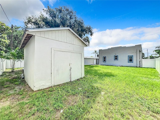 view of outbuilding featuring a lawn