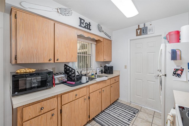 kitchen with white fridge, stove, and light tile patterned floors