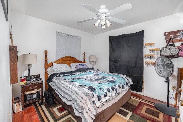 bedroom with ceiling fan and dark wood-type flooring