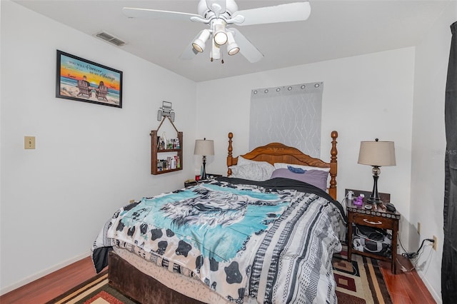 bedroom with ceiling fan and hardwood / wood-style floors