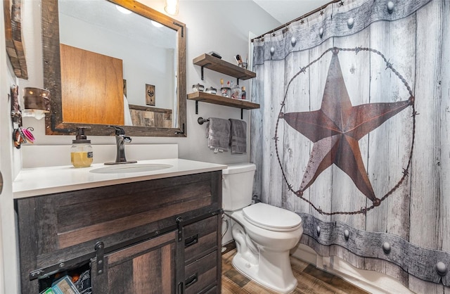 bathroom featuring hardwood / wood-style floors, vanity, toilet, and a shower with curtain