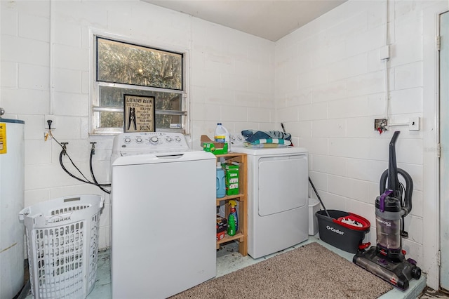 laundry area with gas water heater and washer and dryer