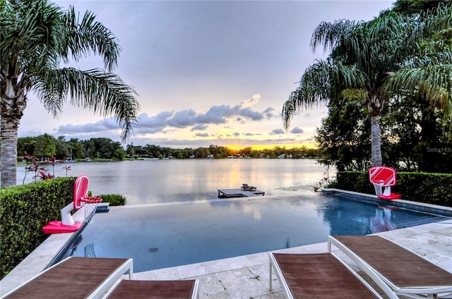pool at dusk with a water view