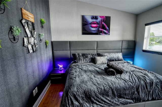 bedroom featuring vaulted ceiling and hardwood / wood-style floors