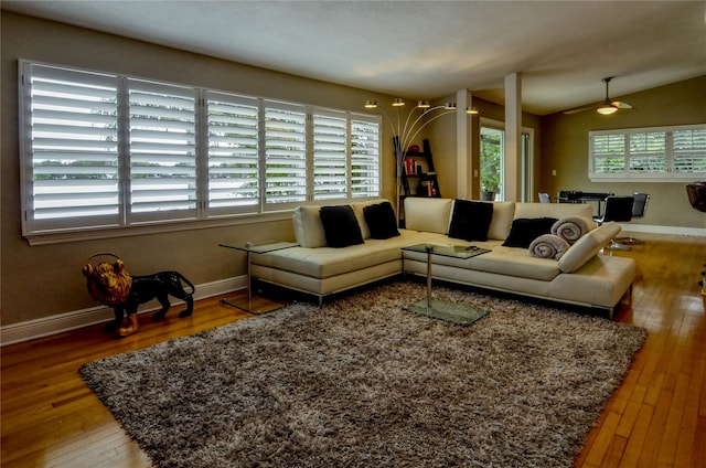 living room featuring hardwood / wood-style flooring, vaulted ceiling, ceiling fan, and plenty of natural light