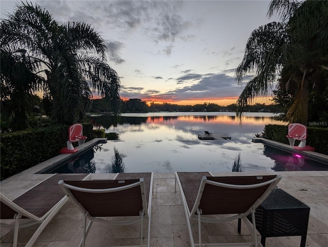 patio terrace at dusk with a water view