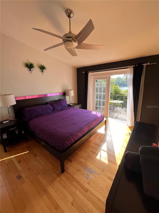 bedroom featuring ceiling fan, light wood-type flooring, and access to exterior