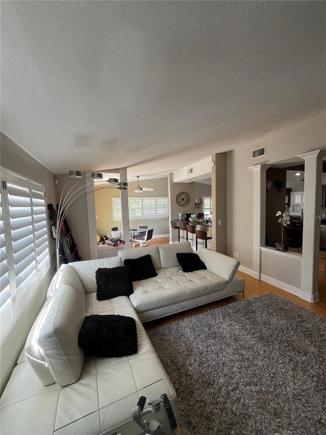 living room with a textured ceiling and visible vents