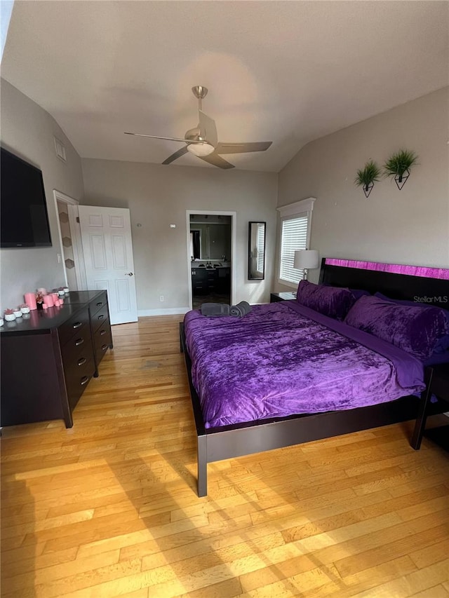 bedroom with baseboards, a ceiling fan, light wood finished floors, and lofted ceiling