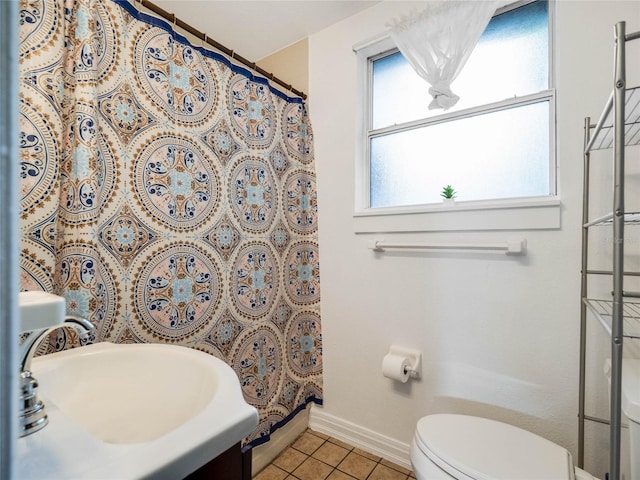 bathroom featuring a shower with curtain, vanity, tile patterned flooring, and toilet