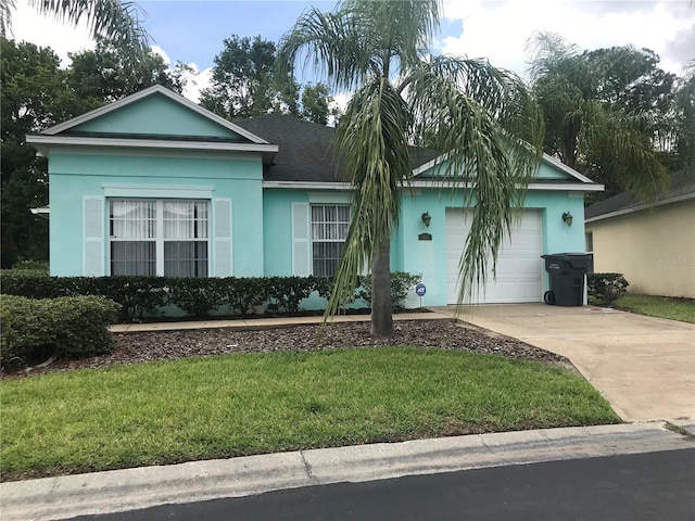 single story home with a garage and a front lawn