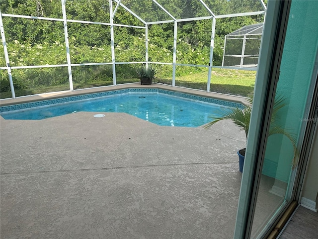 view of swimming pool with a patio and glass enclosure