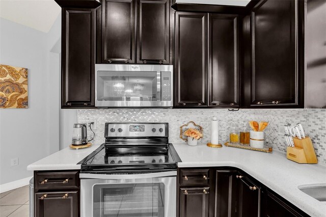 kitchen with decorative backsplash, dark brown cabinetry, appliances with stainless steel finishes, and light tile patterned floors