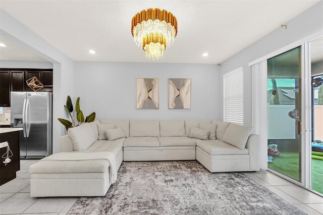 tiled living room with an inviting chandelier